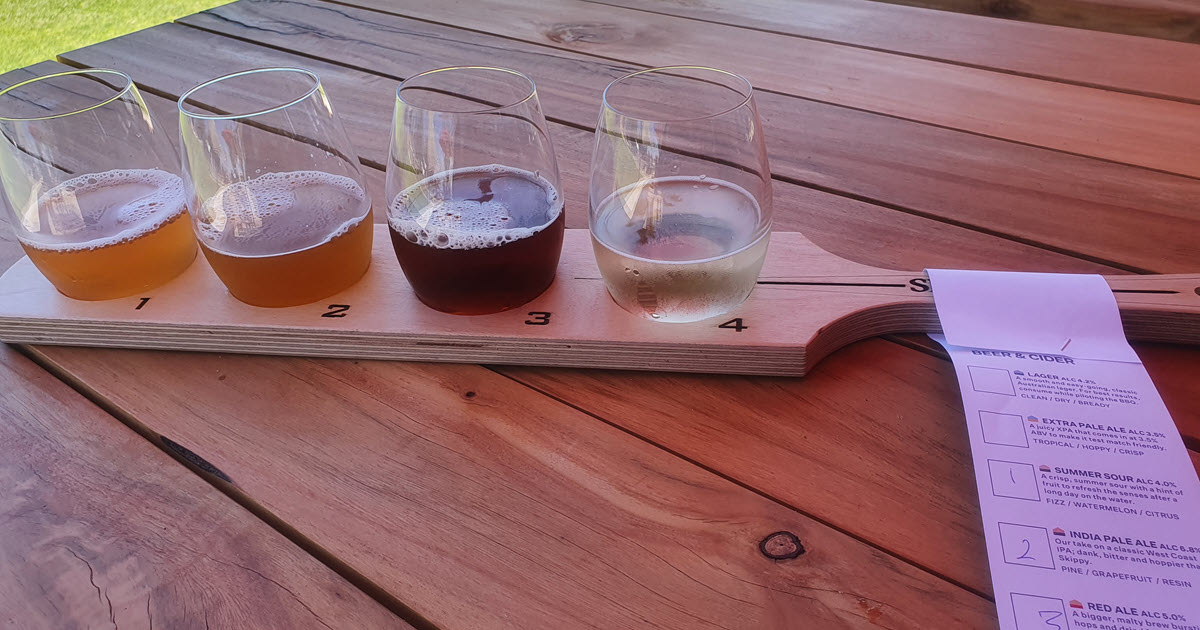 Beer paddle showcasing four Shelter Brewing Co beers.